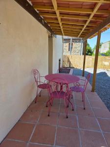 a pink table and chairs on a patio at Lazy Days Gite in Rancon