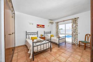 a bedroom with two bunk beds and a balcony at Villa Ricardo by Villa Plus in Carvoeiro