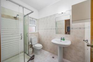 a bathroom with a toilet and a sink and a shower at Villa Ricardo by Villa Plus in Carvoeiro +18 photos
