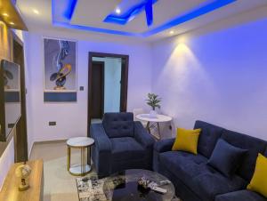 a living room with a couch and two chairs at Kroft Residence in Lekki