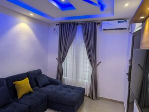 a living room with a blue ceiling at Kroft Residence in Lekki