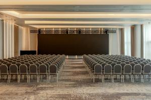 an empty room with chairs and a projection screen at Marriott Corrientes in Corrientes +83 photos