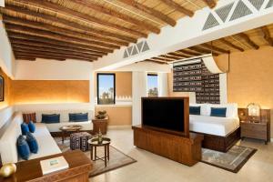 a bedroom with a bed and a tv in a room at Bab Samhan, a Luxury Collection Hotel, Diriyah in Riyadh