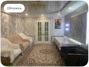 a bathroom with two beds and a tub in it at Nurs Home in Dzhenish