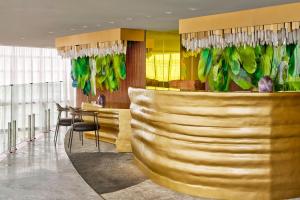 a lobby with a bar with green and yellow walls at W Sao Paulo in São Paulo