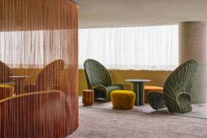 a room with chairs and a table and a window at W Sao Paulo in São Paulo