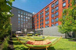 a hammock in a park in front of a building at Aloft by Marriott Providence Downtown in Providence