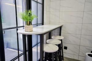 a small table with three stools and a plant on it at Duplex Garden Villa with Private Courtyard Jing'an Villa Near Metro Downtown Shanghai in Shanghai +48 photos
