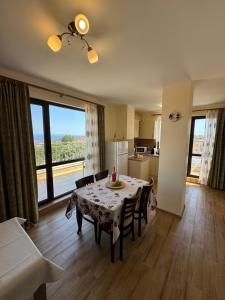a living room with a table and a kitchen with a view at Luxury Apartments Ekaterina in Chernomorets