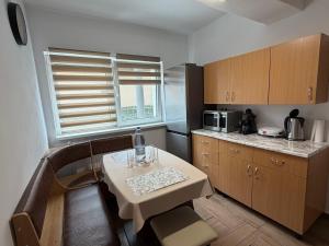 a small kitchen with a table and a microwave at Casa Crisan in Topliţa