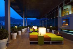 a hotel room with a row of beds and plants at Aloft by Marriott Bursa Hotel in Bursa