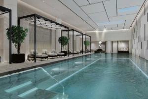 a large swimming pool with blue water in a building at The Ritz-Carlton, Suzhou in Suzhou