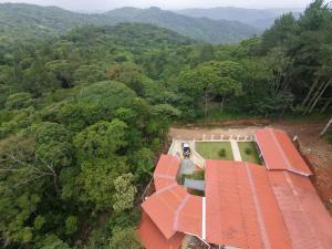 an aerial view of a house in the middle of a forest at Rustic House in Cerro azul in Cerro Azul