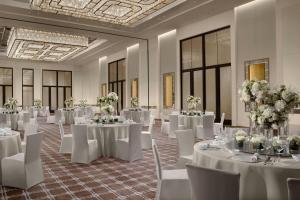 a banquet hall with white tables and chairs and flowers at The Ritz-Carlton, Suzhou in Suzhou +111 photos