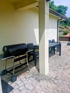 a group of chairs and tables on a patio at Relax House - Casa Castor in Valdosende