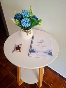 a table with a vase of flowers and a sign on it at Relax House - Casa Castor in Valdosende