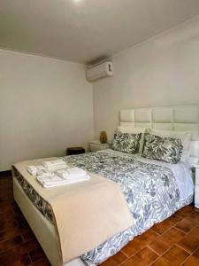 a bedroom with a large bed with towels on it at Relax House - Casa Castor in Valdosende +7 photos