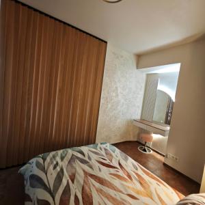 a bedroom with a large bed and a window at Old town boutique apartaments in Ukmergė