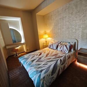a bedroom with a bed and a wall at Old town boutique apartaments in Ukmergė