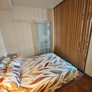 a bedroom with a bed with a glass door at Old town boutique apartaments in Ukmergė