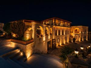a large building with lights on it at night at Duven Hotel Cappadocia in Uçhisar
