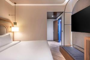 ein Schlafzimmer mit Bett und Flachbildfernseher in der Unterkunft AC Hotel Palacio Universal by Marriott in Vigo