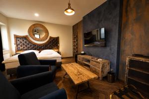 a hotel room with a bed and a mirror at Boutique rooms Fabrika in Děčín