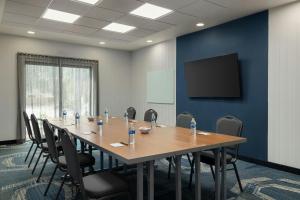 a conference room with a long wooden table and chairs at SpringHill Suites by Marriott - Tampa Brandon in Tampa +51 photos