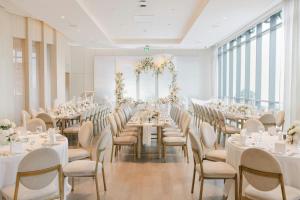 a banquet hall with white tables and chairs at The Pearle Hotel & Spa, Autograph Collection in Burlington +116 photos
