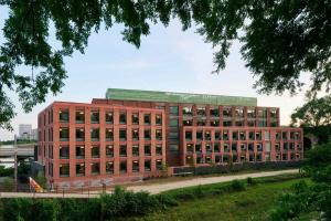 a large red brick building with a green roof at citizenM Washington DC Georgetown in Washington, D.C.