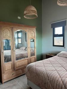 a bedroom with a wooden dresser and a bed at Finca Rosablanca Casa Jazmin in Vista Flores +11 photos
