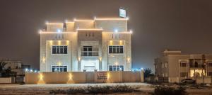 a building with lights on top of it at night at فلل فاخرة للإيجار صلالة Salalah Villas in Salalah