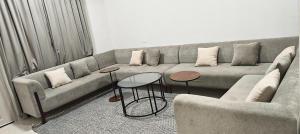 a living room with a couch and two tables at فلل فاخرة للإيجار صلالة Salalah Villas in Salalah +4 photos