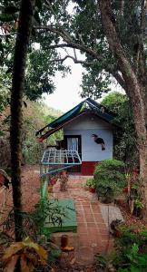 a small house with a bird on the side of it at WeK Homes in Kumbla