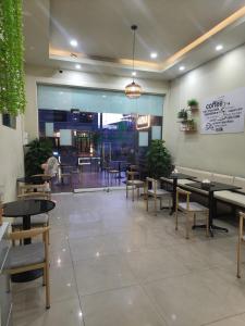 a dining room with tables and chairs in a restaurant at Aroma Hostel in Vientiane