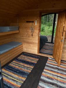 an outside view of a cabin with the door open at Log Off Männivälja forest cabins in Odulemma