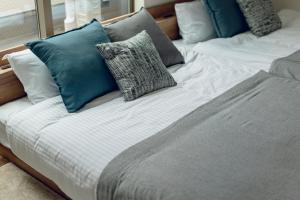 two beds with blue and white pillows on them at Sion MINATO in Nagoya