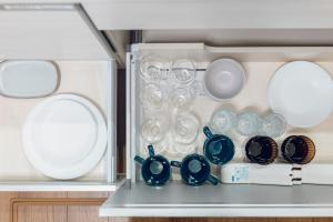 an open refrigerator with dishes and utensils in it at Sion MINATO in Nagoya +82 photos
