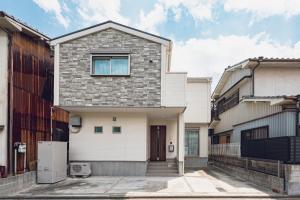 a white house with a stone facade at Sion MINATO in Nagoya