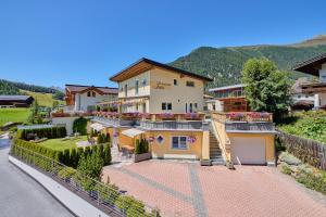 a house on a hill with a driveway at Appartement Lea in Niederthai