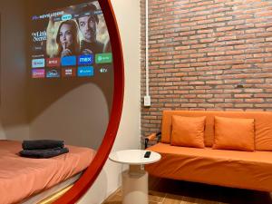 a room with a mirror and a couch and a table at The Miá home in Can Tho