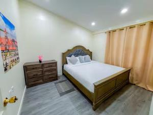 a bedroom with a bed and a dresser in a room at Central Luxury Apartments in Georgetown +35 photos
