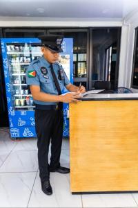 a police officer standing at a counter in a store at Central Luxury Apartments in Georgetown