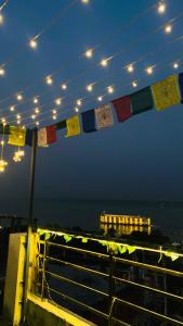 a group of flags hanging from a string at night at The Third Space Varanasi in Rāmnagar