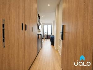 a hallway with wooden doors in a room at Well 100 by JALO in Bogotá