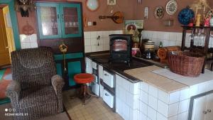 a kitchen with a counter with a stove in it at Chata Johanka in Stachy
