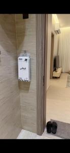 a room with a wall with a box on the wall at Elite stay 1 in Buraydah
