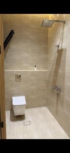 a bathroom with a toilet and a shower at Elite stay 1 in Buraydah