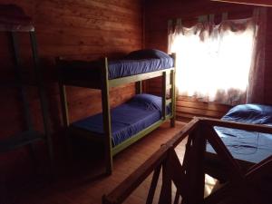 two bunk beds in a room with a window at Complejo Medanales del Sur in Balneario Reta