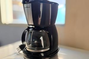 a black coffee maker sitting on top of a counter at Chalé Ilhamar c/ garagem in Ilhabela